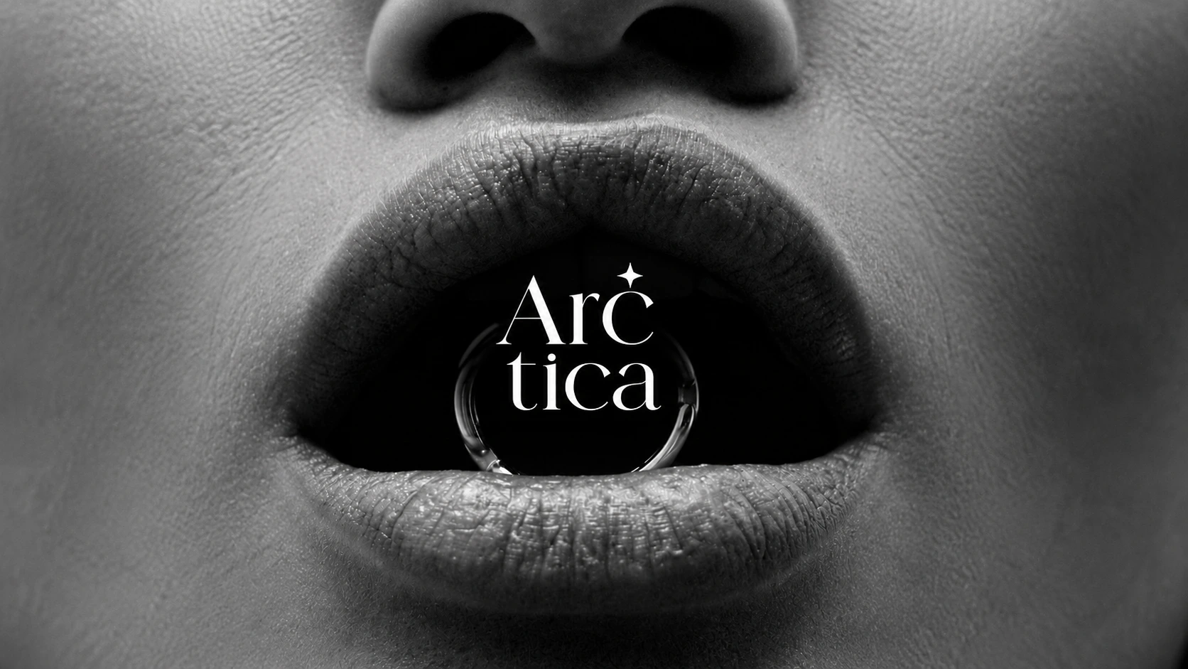 Arctica ring held between monochrome lips