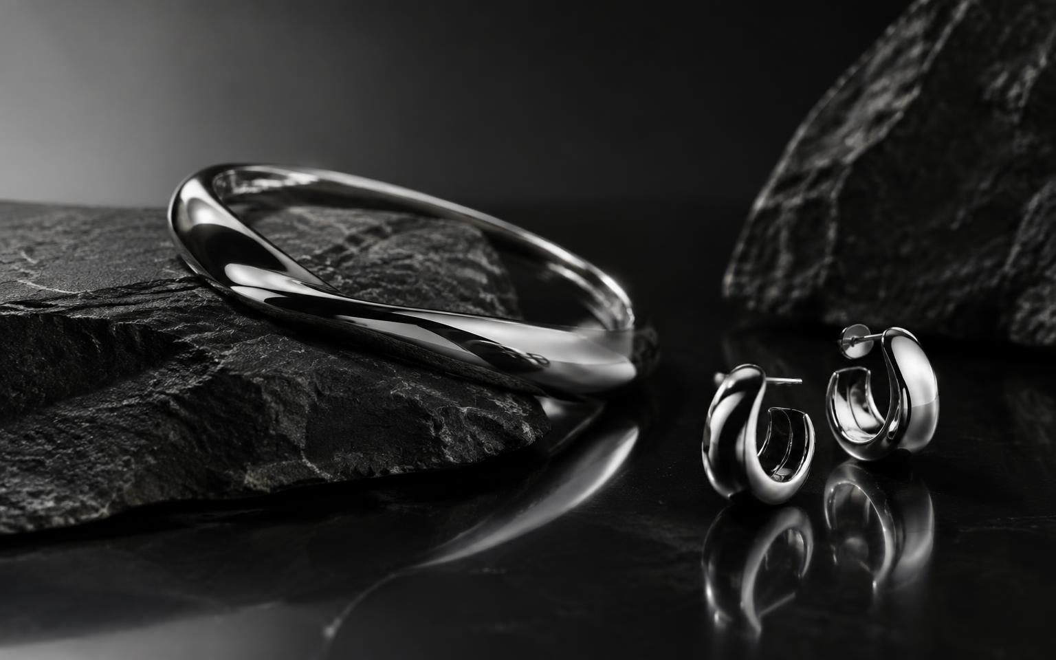 Polished sterling silver jewellery on dark stone